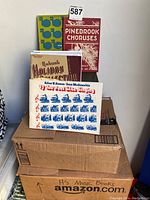 Stack of vintage music and piano instruction books, including Pinedbrook Choruses, Rubank Holiday, and You Feel Like Singin' songbook.