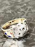 Oblique view showing white gold eagle motif and enamel accents on shoulder