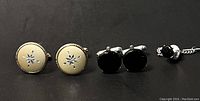 Photo showing all four items: two pairs of cufflinks and one tie tac with chain.