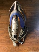 Top view of the clothing iron showing the entire iron including power cord and control buttons