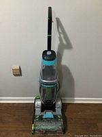 Full view of the Bissell Preheat upright carpet cleaner showing handle, tanks and base.