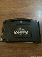 Top view of the closed Diamond Scrabble game set case showing the logo and diamond symbol