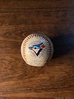 Baseball showing Toronto Blue Jays logo and part of the signatures on the ball.