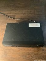 Top view of the black Sony VHS player with power cord visible.