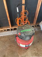 Full view of Jobmate air compressor with orange air hose wrapped around handle, showing overall condition and setup.