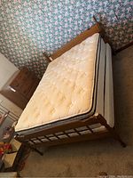 Double bed with wood headboard and footboard and metal rails, mattress and boxspring included optionally.