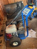 Pressure washer full view showing engine, frame and wheels