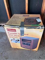 Box of Classic Portable Infrared PTC Heater Model YD-904 with wood-style cabinet image and key features.