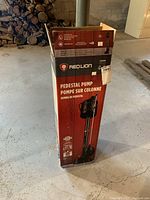 Photo of the boxed Red Lion pedestal pump showing full packaging with branding and product image.