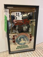 Front view of the Pepsi Cola decorative framed mirror showing the clock, logo, and vintage art with dimensions tape on the side.