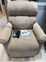 Front view of beige fabric power lift recliner chair