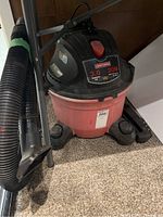 Front-side view of the Craftsman shop vac, showing red bucket base and black top housing with model label and power switch.