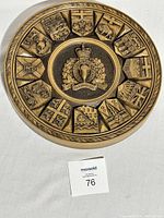 Full view of the circular wood carved plaque showing the RCMP crest and provincial crests around the outer ring.