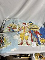 Full view of the three-piece vintage McDonald's twin bed sheet set laid out, showing Ronald McDonald and Mayor McCheese prominently.