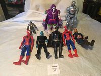 Photo showing all eight assorted action figures arranged in two rows on a white cloth background