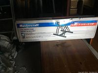 Boxed Mastercraft 2-Bike Bicycle Stand showing brand, size compatibility (23-5/8, 21, 21-3/32, 22 7/16 inches), and design on side label.