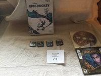 Second angle showing same items (Disney Epic Mickey Wii game, four Nintendo DS cartridges, Civilization IV and World of Warcraft PC games).
