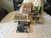 Wide view of all five items laid on a bed, showing titles and covers