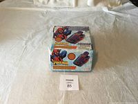 Photo of the unopened retail box of the Spider-Man cordless phone showing front packaging with web and Spider-Man artwork.