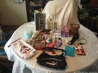 All assorted items including cosmetics, accessories, and household items arranged on a covered chair.