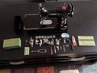 Overview of sewing machine, case and all accessories laid out