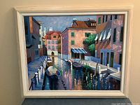 Full frontal view of framed oil painting depicting a canal scene with gondolas and colorful buildings