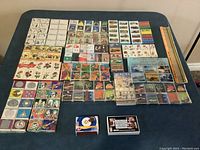 Full layout of all matchboxes and matchbooks displayed on blue surface