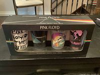 Original box containing 4 Pink Floyd drinking glasses with clear window showing all glasses and packaging details