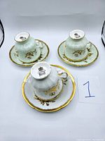 Photo of three upside-down Paragon teacup and saucer sets showing the bottom marks and overall design.