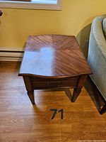 Top view of the wood side table showing veneer grain pattern and surface scratches
