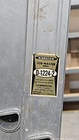 Close-up label showing Werner Job-Master model D-1224-2, 24 ft total length, 21 ft working length, 225 lb duty rating, commercial type.