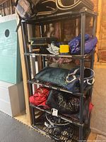 Shelving unit with bags, mats, fire pit visible showing lot contents