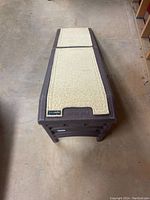 Folded pet ramp top view showing textured beige skid pad surface and hard plastic brown frame with Pet Gear label.