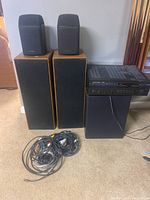 Photo of entire lot showing receiver, floor speakers, smaller Optimus speakers on top, JBL subwoofer and a bundle of cables.