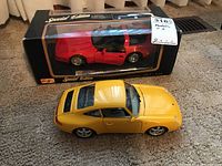 Red Maisto Special Edition Corvette ZR-1 1:18 scale model car in original box with clear display window and black/gold detail. Model car displayed with open driver door.