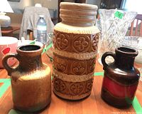 View of the three pottery vases grouped together on a table showing size and finish differences.
