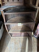 Front view of 3-tier barrel shelf showing all three semi-circular shelves inside the barrel frame.