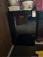 Front view of glossy black Hisense mini fridge showing reflective surface and logo.