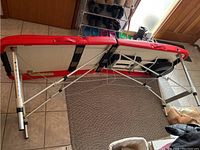 Underside view of HomCom folding massage table showing aluminum frame, support cables and foldable legs