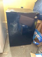Front full view of black Igloo mini fridge showing door and logo.