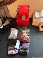 Photo showing red handbag brand Hefang and nine fabric coin purses with intricate embroidery and some new in packaging