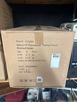 Photo of the box showing part number 111294, 6 pieces of Saturn 13" fluorescent ceiling light fixtures in brushed nickel.