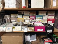 Shelf of boxed women's shoes with several pairs on display, predominantly size 7 and 7.5