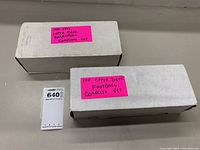Two white storage boxes labeled as containing 1991 Upper Deck basketball and football complete card sets.