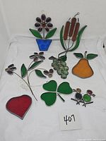 All eight colorful stained glass suncatchers displayed together on white background.