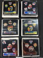 Photo of all six NASCAR pin sets in original clear boxes, showing multiple pins in each black mount card