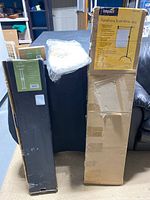 Image showing multiple boxed photography items including the Impact PortaFrame Scrim Kit and Axler camera slider boxes.