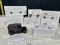 Seven boxed UPS truck models with one displayed outside its box