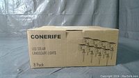 Box front showing brand Conerife, product type LED Solar Landscape Lights, and quantity 8 pack