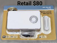 Front packaging photo showing the white Hampton Bay Wireless MP3 Doorbell Kit including doorbell unit, push button, and mounting hardware in plastic display.